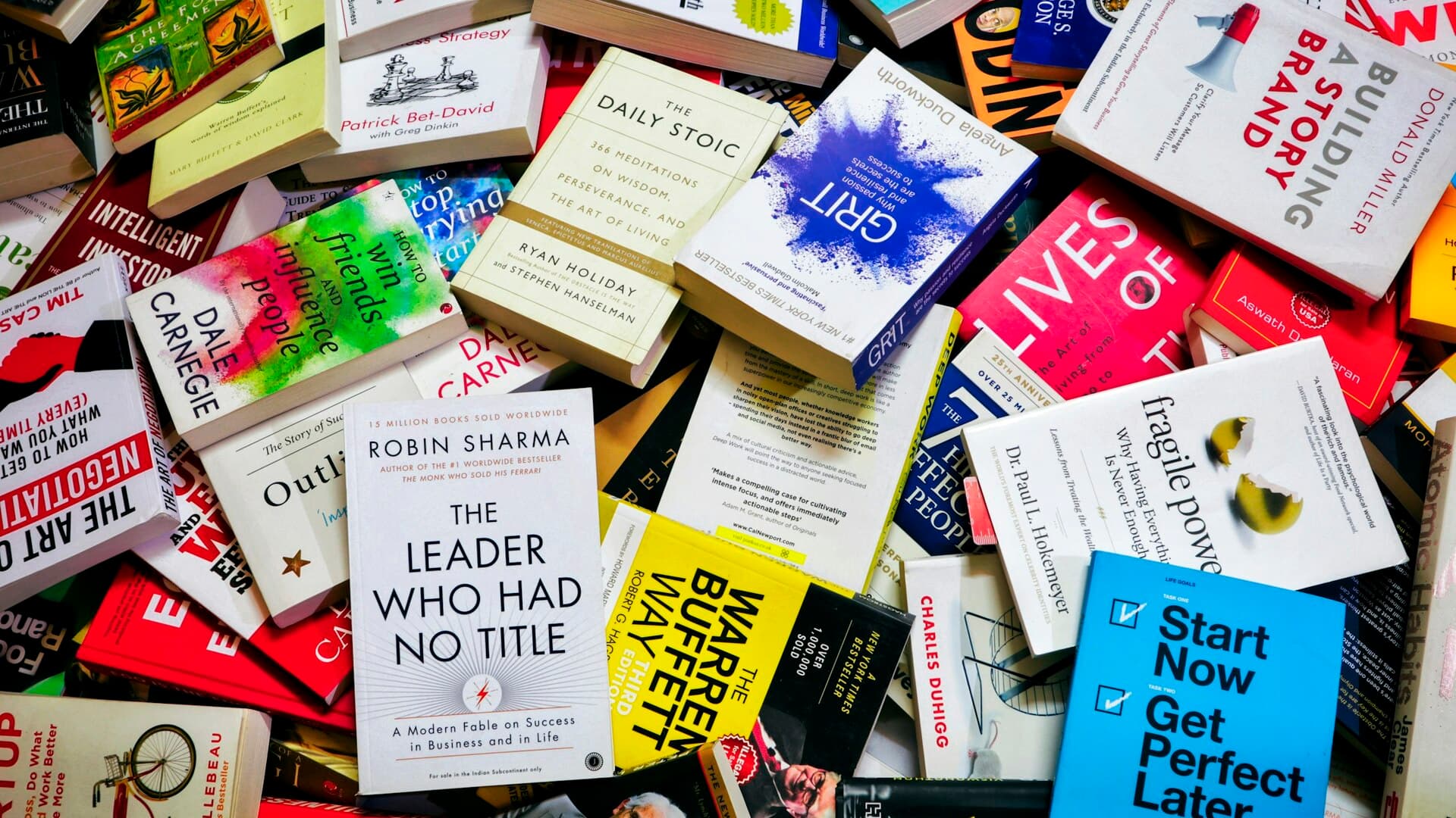 Desk with personal development books arranged for a 2025 reading plan